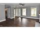 Bright living room features wood floors, neutral paint, and large windows that provide an abundance of natural light at 3209 Leebrook Rd, Raleigh, NC 27616