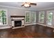 Spacious living room boasts hardwood floors, a fireplace, multiple windows and lots of natural light at 3209 Leebrook Rd, Raleigh, NC 27616