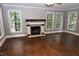 Spacious living room featuring a fireplace, hardwood floors, and plenty of natural light at 3209 Leebrook Rd, Raleigh, NC 27616