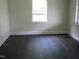A spacious bedroom with hardwood floors and a bright window at 3514 S Alston Ave, Durham, NC 27713