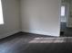 Bedroom featuring a hardwood floor, white baseboards, and natural lighting at 3514 S Alston Ave, Durham, NC 27713