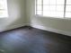 Bedroom featuring two windows with dark vinyl plank flooring at 3514 S Alston Ave, Durham, NC 27713