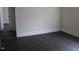 Bedroom with wood paneled walls, white trim, and dark flooring at 3514 S Alston Ave, Durham, NC 27713