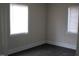 Bedroom with white trim, a window, and dark flooring at 3514 S Alston Ave, Durham, NC 27713
