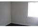 Bright bedroom featuring a window with wooden trim and dark floors at 3514 S Alston Ave, Durham, NC 27713