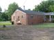 Cozy, one-story brick house featuring a chimney and mature trees at 3514 S Alston Ave, Durham, NC 27713