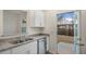 Bright kitchen with stainless steel appliances, granite countertops, and a walkout to the backyard at 416 Ember St, Sanford, NC 27330