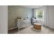Charming Bedroom features whimsical wallpaper, comfortable chair, and bright natural light at 51 Esther Ct, Lillington, NC 27546