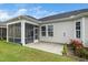 Backyard with a view of the screened porch, a concrete patio, and well-maintained landscaping for outdoor living at 512 Courtship Cv, Durham, NC 27703