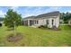 Landscaped backyard featuring a tree and a screened porch, offering a tranquil and well-maintained outdoor space at 512 Courtship Cv, Durham, NC 27703