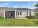 Backyard featuring a screened porch, a concrete patio, and lush landscaping, offering a private outdoor space at 512 Courtship Cv, Durham, NC 27703