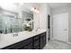 Bathroom with double sink vanity, modern fixtures, and a view of the tiled shower and floors at 512 Courtship Cv, Durham, NC 27703