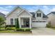 Charming single Gathering home with two-car garage, welcoming porch and manicured landscaping at 512 Courtship Cv, Durham, NC 27703