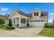 Charming single Gathering home with two-car garage, welcoming porch and manicured landscaping at 512 Courtship Cv, Durham, NC 27703