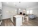 Spacious kitchen with island, open to living area, modern finishes and flooring at 512 Courtship Cv, Durham, NC 27703