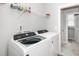 Functional laundry room with modern washer, dryer, and shelving for storage at 512 Courtship Cv, Durham, NC 27703