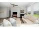 Open living area with a fireplace, neutral-toned sofa, and dark hardwood floors at 512 Courtship Cv, Durham, NC 27703
