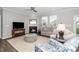 Open-concept living room features a fireplace, hardwood floors, and neutral color palette at 512 Courtship Cv, Durham, NC 27703