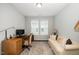 Cozy home office with wood desk, sofa, neutral color palette and natural light at 512 Courtship Cv, Durham, NC 27703