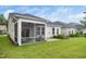Exterior view of a home highlighting the screened-in porch and manicured lawn, perfect for outdoor enjoyment at 512 Courtship Cv, Durham, NC 27703