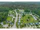 A beautiful community featuring homes surrounded by lush greenery and a serene pond, perfect for nature lovers at 518 Clearfield Dr, Durham, NC 27703