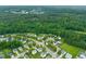 An aerial view of a vibrant neighborhood adjacent to a lush forest, combining suburban living with natural splendor at 518 Clearfield Dr, Durham, NC 27703