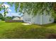 Nice backyard with a lush green lawn, concrete patio, and light-blue siding on the home at 518 Clearfield Dr, Durham, NC 27703