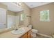 A well-lit bathroom featuring a sink, toilet, and shower/tub combination at 518 Clearfield Dr, Durham, NC 27703