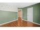 Empty bedroom with leafy decorative accents on the wall over hardwood floors at 518 Clearfield Dr, Durham, NC 27703