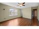 Bedroom with hardwood floors, a ceiling fan, and a large window providing natural light at 518 Clearfield Dr, Durham, NC 27703