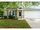 Charming two-story home with stone accents, light blue siding, and well-maintained landscaping at 518 Clearfield Dr, Durham, NC 27703