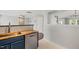 Cozy kitchen featuring butcher block countertops, stainless steel dishwasher, and tile backsplash at 518 Clearfield Dr, Durham, NC 27703
