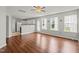 Bright living room features hardwood floors, natural light, and open layout to the kitchen with white cabinets at 518 Clearfield Dr, Durham, NC 27703