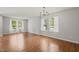 Open living room with hardwood floors, chandelier, and bright natural lighting at 518 Clearfield Dr, Durham, NC 27703