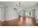 Spacious living room with hardwood floors, chandelier, and staircase at 518 Clearfield Dr, Durham, NC 27703
