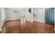 Open living room layout with hardwood floors connecting to the stairs and front entrance at 518 Clearfield Dr, Durham, NC 27703