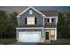 Charming two-story home with a two-car garage, gray siding, and a well-manicured lawn and landscaping at 521 Prestonfield Way, Raleigh, NC 27603