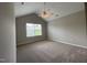 Carpeted bedroom with ceiling fan, window, and vaulted ceilings at 545 Writers Way, Morrisville, NC 27560