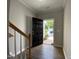 View through an open black front door with wood-look floors and staircase nearby at 545 Writers Way, Morrisville, NC 27560