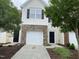 Two-story home featuring a one-car garage with stone accents and a manicured front yard at 545 Writers Way, Morrisville, NC 27560