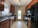 Kitchen featuring brown cabinets, laminate countertops, and stainless steel sink at 545 Writers Way, Morrisville, NC 27560