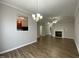 View of the living area and kitchen with a view of the fireplace at 545 Writers Way, Morrisville, NC 27560