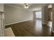 Open living room with wood flooring and a fireplace, next to a dining area at 545 Writers Way, Morrisville, NC 27560