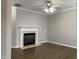 Living room features a fireplace, ceiling fan, and vinyl floors at 545 Writers Way, Morrisville, NC 27560