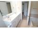 A bathroom has a double sink vanity and a view of the soaking tub and shower at 5916 Longeria Ct, Raleigh, NC 27612