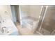 Spacious bathroom featuring a soaking tub and a separate glass-enclosed shower at 5916 Longeria Ct, Raleigh, NC 27612