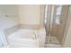 Spacious bathroom featuring a soaking tub and a separate glass-enclosed shower at 5916 Longeria Ct, Raleigh, NC 27612