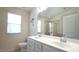 Bathroom with double sink vanity, large mirror, and walk-in shower at 5916 Longeria Ct, Raleigh, NC 27612