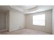A bedroom has a decorative tray ceiling and a window allowing natural light at 5916 Longeria Ct, Raleigh, NC 27612