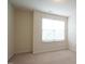 Bedroom with neutral carpet, light walls and a bright window at 5916 Longeria Ct, Raleigh, NC 27612